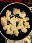 Marinated Chicken coated with batter and put on pan to shallow fry
